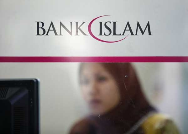 An employee of Bank Islam works at a branch in Putrajaya outside Kuala Lumpur