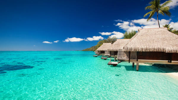 Villas on the green tropical beach with steps into water